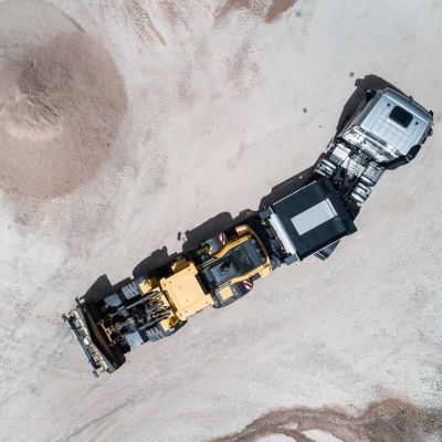 Aerial view of the DOLL low-loader on a construction site, loaded with a construction site vehicle